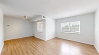 Located in Crofton, MD, this single-floor residence offers 2 bedrooms and 2 bathrooms with a clean, modern aesthetic throughout. The open living area makes a strong first impression with light-toned hardwood-style flooring, crisp white walls, and multiple windows fitted with blinds that allow an abundance of natural light to fill the space. A track light fixture adds a contemporary touch to the living area.

The kitchen is thoughtfully updated, featuring white shaker-style cabinetry, granite-look countertops, a stainless steel refrigerator, dishwasher, and a single-basin sink — combining both style and functionality in a compact, efficient layout.

Each bedroom is finished with plush neutral carpeting and includes a window with outdoor views, creating a calm and comfortable atmosphere. The primary bedroom offers a generous footprint and includes closet access. Additional bedrooms provide flexible space suitable for sleeping, a home office, or other uses.

The two bathrooms maintain a clean, minimalist design. One bathroom features floor-to-ceiling white ceramic tile in the shower/tub area with chrome fixtures, while the second includes a white vanity with countertop, a mirror, and hardwood-style flooring. A connecting hallway ties all rooms together efficiently, completing this well-organized and move-in-ready home.