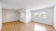 Located in Crofton, MD, this single-floor residence offers 2 bedrooms and 2 bathrooms with a clean, modern aesthetic throughout. The open living area makes a strong first impression with light-toned hardwood-style flooring, crisp white walls, and multiple windows fitted with blinds that allow an abundance of natural light to fill the space. A track light fixture adds a contemporary touch to the living area.

The kitchen is thoughtfully updated, featuring white shaker-style cabinetry, granite-look countertops, a stainless steel refrigerator, dishwasher, and a single-basin sink — combining both style and functionality in a compact, efficient layout.

Each bedroom is finished with plush neutral carpeting and includes a window with outdoor views, creating a calm and comfortable atmosphere. The primary bedroom offers a generous footprint and includes closet access. Additional bedrooms provide flexible space suitable for sleeping, a home office, or other uses.

The two bathrooms maintain a clean, minimalist design. One bathroom features floor-to-ceiling white ceramic tile in the shower/tub area with chrome fixtures, while the second includes a white vanity with countertop, a mirror, and hardwood-style flooring. A connecting hallway ties all rooms together efficiently, completing this well-organized and move-in-ready home.