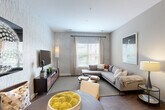 Located at 70 Upper Rock Circle in Rockville, MD, this well-appointed one-bedroom, one-bathroom residence offers a thoughtfully designed open-concept layout with contemporary finishes throughout. The kitchen is a standout feature, showcasing rich dark cabinetry, stainless steel appliances including a French door refrigerator, electric range, built-in microwave, and dishwasher, all complemented by a mosaic tile backsplash and a generous granite-topped island with pendant lighting — ideal for both meal prep and casual dining. The kitchen flows seamlessly into the combined living and dining area, where wood-style flooring, textured accent walls, and large windows allow natural light to fill the space. The living room provides a comfortable and stylish setting with ample room for relaxing or entertaining. The bedroom offers a calm, neutral retreat with plush carpeting, a large window with outdoor views, and dedicated closet space. The bathroom features full-wall tile surrounding a soaking tub and shower combination, with a dark-finished vanity adding a modern touch. Track lighting, quality door hardware, and a cohesive neutral color palette tie the entire residence together into a polished, move-in-ready home.
