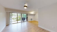 Located at 7204 Groveton Gardens Rd in Alexandria, VA, this two-bedroom, one-bathroom residence offers a well-organized single-floor layout designed for comfortable everyday living. The main living area is bright and open, featuring light wood-style flooring, neutral walls, and large sliding glass doors that lead to a private balcony overlooking lush greenery — filling the space with natural light and outdoor views.

The kitchen is efficiently designed with grey shaker-style cabinetry, white countertops, and a full suite of stainless steel appliances including a gas range, dishwasher, and refrigerator. A breakfast bar provides additional counter space and a casual dining option.

Both bedrooms are carpeted for comfort and feature closet space. The primary bedroom is generously sized and includes a walk-in closet equipped with built-in wire shelving and hanging rods for organized storage. The second bedroom also features a closet with shelving. One bedroom benefits from a large sliding window with vertical blinds, allowing for abundant natural light.

The full bathroom is clean and functional, featuring white subway tile, a single vanity with wood cabinetry, a framed mirror, and a tub-shower combination. Throughout the residence, the neutral color palette and practical layout create a bright, livable ambiance well-suited for Alexandria living.