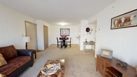 Located at 11611 Dyer St in El Paso, TX, this single-story residence offers a well-organized, functional layout across its living spaces. The living room is generously sized, featuring plush carpeting, a textured ceiling, and a large sliding glass door that fills the room with natural light and provides access to an outdoor patio area. The open flow connects seamlessly to the dining area, which is defined by neutral walls and carpet, and sits adjacent to the kitchen via a convenient pass-through counter. The kitchen is equipped with granite-style countertops, white cabinetry, a white range, and tile flooring, along with a louvered pantry door for additional storage. The bedroom is a comfortable retreat, featuring multiple windows that invite natural light, soft carpeting, and a spacious walk-in closet with built-in shelving. The full bathroom includes a granite-top vanity, tile flooring, and a shower-tub combination. Throughout the space, neutral tones and carpet create a cohesive, welcoming ambiance, while the sliding patio door in the living area provides an added connection to the outdoors.