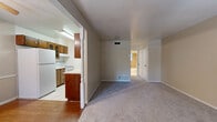Located at 9310 Starcrest Drive in San Antonio, Texas, this single-story, one-bedroom, one-bathroom home offers a practical and well-organized layout. The open living area features neutral-toned carpet and connects seamlessly to the dining room, creating a comfortable shared space for everyday living. The kitchen is positioned adjacent to the dining area and is equipped with classic wood cabinetry, light countertops, a white range, a dishwasher, and a refrigerator, all set on easy-to-clean tile flooring. A decorative post column visually separates the kitchen and dining areas from the carpeted living space, adding a subtle architectural detail. The bedroom is a generously sized retreat with plush carpeting, a ceiling fan with light fixture, natural light from a window with blinds, and dual closets with bi-fold doors offering ample storage. The full bathroom features tile flooring, a tiled tub-and-shower combination, a toilet, and a vanity with storage. Additional highlights include a dedicated utility room, multiple closets throughout, and consistent ceiling fans providing comfort across the home.