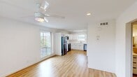 Located at 1304 McKie Dr in Austin, TX, this well-designed 3-bedroom, 2-bathroom unit offers a clean, modern aesthetic throughout. The open-concept living and kitchen area is anchored by warm light wood flooring and crisp white walls, with a ceiling fan and recessed lighting providing both comfort and brightness. Large windows invite abundant natural light and offer views of the surrounding greenery, enhancing the airy feel of the shared space.

The kitchen is thoughtfully appointed with white shaker-style cabinetry, light countertops, a stainless steel sink beneath a window, and a full suite of appliances including a refrigerator, range, microwave, and dishwasher. A skylight-style ceiling fixture adds additional illumination to the workspace.

Each of the three bedrooms continues the cohesive wood flooring and neutral palette, with ceiling fans, ample natural light, and closets providing practical storage. The primary bedroom features a sliding glass door that opens to an outdoor balcony area. Two bathrooms mirror the clean design language of the home, featuring white vanities with storage cabinetry, mirrors, and neutral tile wainscoting that extends throughout both rooms. Together, the spaces create a cohesive, move-in-ready home in the heart of Austin.