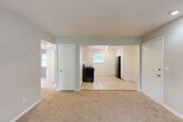 Located at 1250 Donnelly Ave SW in Atlanta, GA, this single-story, 3-bedroom, 1-bathroom home offers a practical and comfortable layout. The living area features soft carpet flooring, neutral light gray walls, recessed lighting, and a window that invites natural light into the space. The kitchen is efficiently designed with white cabinetry extending to the ceiling for ample storage, light tile flooring, a stainless steel refrigerator, a gas range, and a sink with a window overlooking the outdoors. A door from the kitchen provides direct exterior access.

Each of the three bedrooms features wall-to-wall carpet, ceiling fans with integrated light fixtures, and closets for storage. The spacious primary bedroom offers generous square footage and its own closet. The secondary bedrooms are well-proportioned, each with a window allowing natural light and outdoor views. The hallway connects all rooms efficiently, and three closets throughout the home provide ample storage. The shared bathroom features a tiled tub and shower combination with a window for natural light and ventilation. The home's clean, neutral palette and consistent finishes throughout create a cohesive and move-in ready environment.
