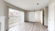 Located at 951 Turner Rd in Grapevine, TX, this one-bedroom, two-bathroom residence offers a well-designed single-floor layout with a thoughtful mix of finishes and functional spaces.

The living room serves as the heart of the home, showcasing light-toned wood-look flooring, a textured ceiling, and a striking white-tiled fireplace with a raised hearth. A full wall of sliding glass doors floods the space with natural light and provides direct access to a private patio. A stylish sliding barn door connects the living area to the bedroom, adding a modern architectural touch.

The bedroom is a comfortable retreat featuring plush carpeting, a ceiling fan, and a window with blinds that lets in ample natural light. It includes access to a dedicated walk-in closet with built-in shelving, offering generous storage.

Two bathrooms serve the unit: one featuring a full soaking tub and shower combo with wood-look flooring, and the other with a white vanity topped with a speckled quartz-style countertop and a large mirror, conveniently situated near the bedroom and closet.

Neutral warm-gray tones carry throughout the space, creating a cohesive and inviting ambiance suited for comfortable everyday living in the heart of Grapevine.