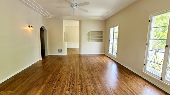 Spacious Living Room with art deco built-in and beautiful architectural details. - 1001 S Holt Ave