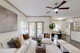 Located at 425 McCaleb Rd in Conroe, TX, this single-story 2-bedroom, 2-bathroom residence offers a thoughtfully designed layout with a neutral, contemporary aesthetic throughout. The open-concept living room is bright and inviting, featuring dark hardwood-style flooring, crown molding, ceiling fans, and multiple windows that flood the space with natural light. A set of glass doors provides access to the outdoors. The dining area sits adjacent to the living space and benefits from additional window views of the surrounding greenery. The kitchen is well-equipped with dark espresso cabinetry, granite countertops, stainless steel appliances, and ample storage. The primary bedroom offers a comfortable, carpeted retreat with a ceiling fan and a spacious walk-in closet. The second bedroom includes its own window and ceiling fan, suitable as a guest room or home office. Both bathrooms are finished with tile flooring and tub-shower combinations with tile surrounds. A dedicated laundry room houses a full-size washer and dryer. The hallway connects all rooms efficiently, and two closets provide generous storage throughout. The overall ambiance is clean, modern, and functional.