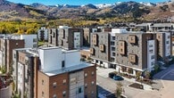 This 430 square foot studio apartment in Park City, Utah, offers a thoughtfully designed living space that maximizes functionality. The open-concept floor plan seamlessly integrates the kitchen, living room, and sleeping area. The modern kitchen boasts wood-grain cabinetry, stainless steel appliances, and a subway tile backsplash, creating a contemporary aesthetic. White quartz countertops provide ample workspace and contrast beautifully with the warm wood tones.

The living area is furnished with sleek, dark leather seating, offering a cozy spot to relax or entertain. Large windows flood the space with natural light and provide picturesque views of the surrounding area. Light wood-look flooring throughout adds warmth and continuity to the space.

The bathroom features a clean, minimalist design with a floating vanity, large mirror, and a walk-in shower. The color palette of whites and neutrals maintains a sense of spaciousness and modernity. Despite its compact size, the apartment's clever layout and design elements create an inviting and functional living environment, perfect for those seeking an efficient urban lifestyle in the heart of Park City.