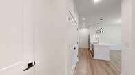 Located at 125 Town Center Dr in Garden City, GA, this well-appointed 1-bedroom, 1-bathroom unit offers a thoughtfully designed open-concept layout that seamlessly connects the living, dining, and kitchen areas. Light wood-tone flooring runs throughout the space, complementing the crisp white walls and creating a clean, modern aesthetic.

The kitchen is a standout feature, showcasing white shaker-style cabinetry with matte black hardware, a subway tile backsplash, stainless steel appliances, and a generous quartz-topped island with an undermount sink and stylish pendant lighting. Ample cabinet storage extends into a dedicated galley-style pantry area, enhancing the kitchen's functionality.

The open living and dining area is bathed in natural light from large windows and features a statement sputnik-style chandelier alongside a ceiling fan. A glass-paneled door provides access to a private outdoor balcony.

The bedroom is a comfortable, well-lit retreat with natural light from a large window and a ceiling fan overhead. A dedicated closet offers convenient storage.

The bathroom features a quartz-topped vanity with white cabinetry, a large framed mirror with matte black accents, and a tiled tub-shower combination. Throughout the unit, Shaker-style interior doors with matte black hardware add a cohesive, contemporary touch.