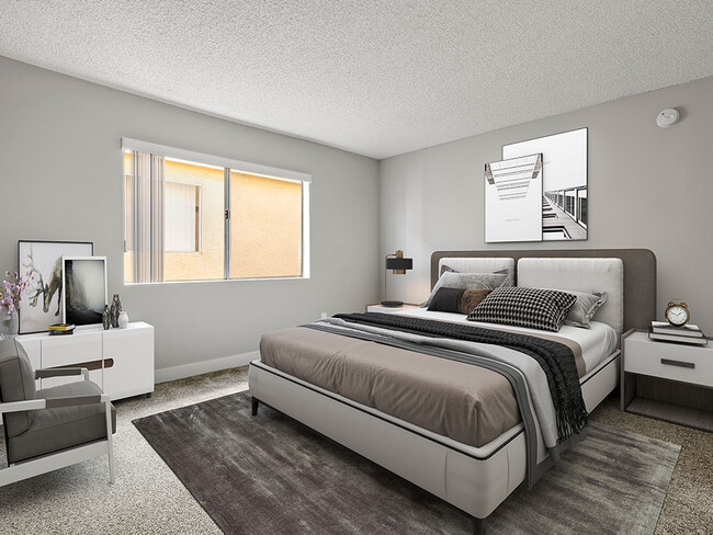 Carpeted bedroom with accent wall and large natural light window. - Riverbridge Apartments