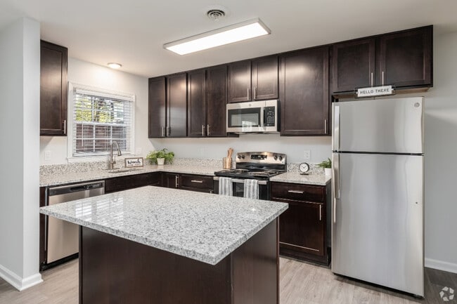 Modern Kitchens with Espresso Cabinetry, Stainless Steel Appliances, & Granite Countertops - Legacy at Tech Center
