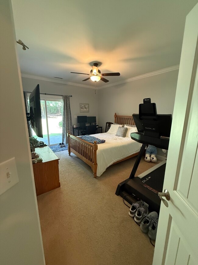 Downstairs bedroom w/ access to courtyard - 2615 Stewart Pines Dr