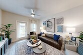 Located at 200 Travis Dr in McDonough, GA, this single-story 2-bedroom, 2-bathroom home delivers a thoughtfully designed open-concept layout with modern finishes throughout. The inviting living room is anchored by wood-look flooring, a ceiling fan, and large windows with access to an exterior door, flooding the space with natural light. A curated gallery wall and ample room for seating make it an ideal gathering area.

The kitchen is outfitted with crisp white shaker cabinetry, granite countertops, a tile backsplash, stainless steel appliances, and generous counter space — complemented by a pantry for additional storage. A breakfast bar connects the kitchen seamlessly to the living area.

The spacious primary bedroom features a ceiling fan, hardwood-style flooring, and a bright window with outdoor views. Its en-suite bathroom offers a dual-sink vanity with granite countertops, white cabinetry, and modern fixtures. The second bedroom and bathroom provide equally comfortable accommodations for guests or household members.

Practical spaces include a dedicated laundry room with full-size washer and dryer, a utility room, four closets, and a hallway connecting the layout efficiently. The overall ambiance is clean, bright, and contemporary — ideal for comfortable everyday living.
