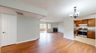 Located at 1171 Allen Ave in Glendale, CA, this 2-bedroom, 2-bathroom unit offers a well-designed single-floor layout with a cohesive blend of comfort and functionality. Warm hardwood-style flooring flows throughout the living areas and bedrooms, complementing the neutral, light gray walls and white trim found throughout the space.

The spacious living room is a standout area, featuring a classic brick fireplace with a white mantel, a sliding glass door opening to a private balcony, and additional windows that invite natural light. A chandelier adds a touch of elegance near the entry. The kitchen is equipped with rich wood cabinetry, granite countertops, stainless steel appliances including a gas range and dishwasher, and a window above the sink for natural light. Tile flooring completes the kitchen's practical design.

The primary bedroom offers generous proportions and includes mirrored sliding closet doors, while a dedicated walk-in closet with built-in shelving provides ample storage. The second bedroom features a large window with views of the surrounding greenery. Both bathrooms are finished with white fixtures and hardwood-style flooring — one with a shower/tub combo and the other with a walk-in shower. Textured ceilings are present throughout the unit.