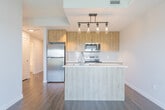 Located at 55 Clairfields Dr E in Guelph, Ontario, this efficiently designed one-bedroom, one-bathroom unit makes excellent use of its compact footprint. The open-concept kitchen and living area serves as the heart of the space, showcasing warm natural wood cabinetry, stainless steel appliances, a white subway tile backsplash, and a sleek central island with an undermount sink and pendant lighting overhead — a functional and stylish focal point. Rich hardwood-style flooring runs throughout, complementing the neutral, warm-toned walls that create a clean and inviting atmosphere. Large windows flood the living area with natural light, while a glass balcony door opens to an elevated outdoor space with treetop and neighbourhood views, enhancing the sense of openness. The hallway connects the main living area to the private bedroom, which is a well-proportioned retreat featuring a large window with a balcony-facing outlook and abundant natural light. The full bathroom is finished with crisp white subway tile surrounding a soaker tub and shower combination, chrome fixtures, and clean, minimal detailing. Throughout, the unit presents a cohesive modern aesthetic with thoughtful finishes suited for comfortable everyday living.