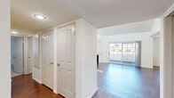 Located at 18418 Dearborn St in Northridge, CA, this single-story, 4-bedroom, 3-bathroom home offers a well-designed layout with a variety of thoughtful features throughout. The living room is a standout space, boasting dramatic vaulted ceilings that create an airy, open atmosphere, rich hardwood flooring, and a classic fireplace flanked by a built-in display niche. Large sliding glass doors flood the room with natural light and provide direct access to an outdoor area, while an adjacent dining space features a pendant light fixture. The kitchen is outfitted with crisp white cabinetry, ample counter space, stainless steel appliances including a gas range, over-the-range microwave, and dishwasher, complemented by hardwood floors. The spacious primary bedroom features vaulted ceilings, plush carpeting, and a generous window with vertical blinds. Additional bedrooms are carpeted and include mirrored sliding closet doors. The three bathrooms are clean and functional, featuring white vanities, large mirrors, and glass-enclosed shower stalls with hardwood-style flooring. A hallway connects the private quarters, maintaining a cohesive and efficient flow throughout this comfortable Northridge home.