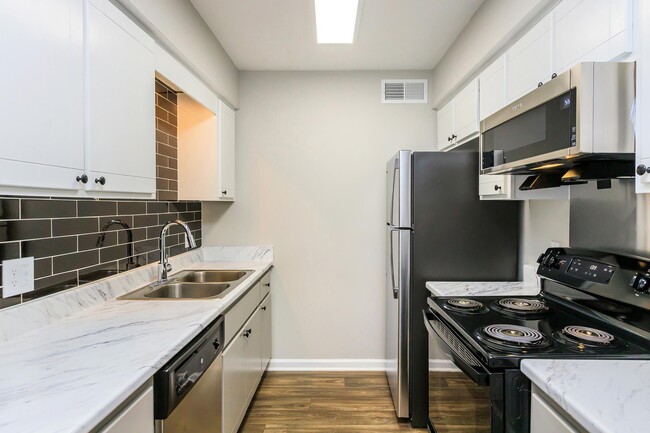 AWESOME KITCHEN WITH WHITE MARBLE STYLE COUNTERTOPS - The Roosevelt Apartment Homes