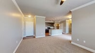 Located at 8515 Clearwater Ln in Indianapolis, IN, this thoughtfully designed single-floor residence offers a comfortable and functional layout. The open-concept living area flows seamlessly into the kitchen, which serves as a true centerpiece of the home. The kitchen features dark espresso cabinetry, granite countertops, a large island with a built-in sink, pendant lighting, track lighting, and stainless steel appliances — all set atop rich hardwood flooring. Crown molding throughout the living and kitchen areas adds a refined architectural detail.

The spacious bedroom is finished with plush carpet, a ceiling fan, and a large window that brings in natural light and outdoor views. Two closets provide ample storage, including a walk-in closet equipped with wire shelving systems. The two bathrooms are well-appointed, with one featuring a soaking tub framed by floor-to-ceiling neutral tile. A dedicated laundry area includes a stacked washer and dryer unit with additional shelving above. The warm, neutral color palette and consistent finishes throughout lend the space a cohesive and inviting ambiance.