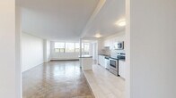 Located at 25 Cougar Crt in Toronto's Scarborough neighbourhood, this well-appointed 2-bedroom, 1-bathroom unit offers a generous and thoughtfully laid-out floor plan. Classic parquet wood flooring flows consistently throughout the living spaces and bedrooms, lending warmth and character to the clean, white-walled interiors.

The open-concept kitchen has been tastefully renovated, featuring crisp white shaker-style cabinetry, dark countertops, a white subway tile backsplash, and a full suite of stainless steel appliances including a refrigerator, range, microwave, and dishwasher. Light porcelain tile flooring completes the kitchen's modern aesthetic. Adjacent to the kitchen, the spacious living room is flooded with natural light through a wide bank of floor-to-ceiling windows, offering pleasant views of the surrounding greenery and Toronto skyline beyond.

The primary bedroom is generously sized with a large window framing treetop views, while the second bedroom is equally bright and versatile. Both rooms benefit from access to multiple closets. The bathroom features clean white subway tile surrounding a full soaker tub and shower, with a simple, functional design. A welcoming hallway connects all areas of the unit, completing this bright and practical home.