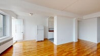 Located at 6920 Avenue Fielding, Suite 602, in Montréal, this well-appointed two-bedroom, two-bathroom unit offers a functional and comfortable layout across a single floor. Warm, honey-toned hardwood flooring runs throughout the living areas and bedrooms, lending the space a bright and inviting character that is further enhanced by large windows drawing in generous natural light and offering views of the surrounding cityscape.

The spacious living room is open and airy, with clean white walls and a seamless flow toward the hallways and bedrooms. The galley-style kitchen features white cabinetry, warm brown countertops, a tile backsplash, and ample storage on both sides, providing an efficient and practical cooking environment.

The primary bedroom is generously sized, with a large window and mirrored sliding closet doors that amplify the sense of space. The second bedroom is equally well-lit, also featuring a window with city views and direct access to one of the two bathrooms.

Both bathrooms carry a distinctive retro aesthetic. One is finished in bold turquoise and navy tiles with a patterned floor, while the second features soft peach and black tiling with a full bathtub and shower combination. Together, they add a unique vintage character to the unit. Two hallways connect the spaces efficiently, completing this well-structured and characterful Montréal residence.