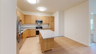 Located at 6822 Shannon Pky in Union City, GA, this single-floor residence offers two bedrooms and two bathrooms within a well-organized layout. The kitchen is a standout feature, equipped with warm honey-toned cabinetry, granite-style countertops, stainless steel appliances including a refrigerator, range, microwave, and dishwasher, and a central island that provides additional workspace and storage. Light hardwood-style flooring runs throughout the main living areas and kitchen, creating a clean, cohesive look. The living area is bright and open, with recessed lighting and windows that invite natural light and views of the surrounding greenery. Both bedrooms are carpeted for comfort and feature large windows fitted with vertical blinds, offering outdoor views and natural light. The primary bedroom is generously sized and includes closet space. The bathrooms are finished with granite-topped vanities, warm wood cabinetry, and light hardwood-style flooring. One bathroom is notably accessibility-friendly, featuring multiple grab bars near the toilet and shower area. Throughout the home, neutral wall tones and clean finishes create a bright, functional, and move-in-ready living environment.