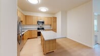 Located at 6822 Shannon Pky in Union City, GA, this single-floor residence offers two bedrooms and two bathrooms within a well-organized layout. The kitchen is a standout feature, equipped with warm honey-toned cabinetry, granite-style countertops, stainless steel appliances including a refrigerator, range, microwave, and dishwasher, and a central island that provides additional workspace and storage. Light hardwood-style flooring runs throughout the main living areas and kitchen, creating a clean, cohesive look. The living area is bright and open, with recessed lighting and windows that invite natural light and views of the surrounding greenery. Both bedrooms are carpeted for comfort and feature large windows fitted with vertical blinds, offering outdoor views and natural light. The primary bedroom is generously sized and includes closet space. The bathrooms are finished with granite-topped vanities, warm wood cabinetry, and light hardwood-style flooring. One bathroom is notably accessibility-friendly, featuring multiple grab bars near the toilet and shower area. Throughout the home, neutral wall tones and clean finishes create a bright, functional, and move-in-ready living environment.