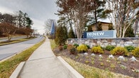 reNEW Howard Crossing is a residential community situated in Ellicott City, Maryland, offering a welcoming and well-appointed setting for its residents. The community's entrance is marked by a prominent stone monument sign, elegantly branded with the reNEW Howard Crossing name and complemented by carefully curated landscaping. Seasonal plantings, ornamental shrubs, and mature trees frame the entryway, creating an inviting first impression that reflects the community's commitment to curb appeal and upkeep.

The property benefits from a highly accessible location at a signalized intersection, providing straightforward connectivity to major roadways in the area. Sidewalks and pedestrian crosswalks are present throughout, supporting walkability and safe access to nearby amenities. The surrounding area includes retail and service establishments within close proximity, adding to the convenience of everyday living.

Decorative banners line the entry approach, enhancing the community's identity and visual character. The mature tree canopy and maintained green spaces contribute to a pleasant, park-like atmosphere along the perimeter. Overall, reNEW Howard Crossing presents a polished and community-focused environment, combining thoughtful exterior design with a practical, well-connected location in one of Howard County's established neighborhoods.