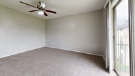 Located at 749 E Pecan St in Hurst, Texas, this single-floor residence features three bedrooms, one bathroom, and a hallway connecting the living areas. The layout is efficient and straightforward, making good use of the available floor space across all rooms.

The bedrooms are finished with neutral-toned carpet and soft gray walls, creating a calm and versatile backdrop. Each room is equipped with a ceiling fan with integrated lighting, promoting air circulation and comfort. The generously sized primary bedroom stands out for its notably spacious footprint, featuring a built-in closet with shelving and hanging rods that provide ample storage. A window in the primary bedroom allows natural light to filter in through blinds.

The secondary bedrooms are comparably appointed, each with carpet flooring, ceiling fans, and clean white trim. One bedroom benefits from direct access to natural light through a window, while another features a door leading to additional areas of the home.

The bathroom is functional and cleanly finished, featuring a full-size soaking tub with an overhead shower, chrome fixtures, and wood-look flooring. The living area connects to an entry door and features carpet flooring consistent with the rest of the home, along with ceiling-mounted HVAC vents for climate control. Overall, the space presents a clean, move-in-ready environment with consistent finishes throughout.