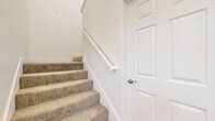 Located in Palm Desert, CA, this two-story, three-bedroom, two-bathroom home offers a well-organized layout across two levels. The main living area is open and airy, featuring plush neutral carpeting, a sliding glass door that invites natural light, and seamless access to the kitchen. The kitchen is thoughtfully designed with crisp white shaker cabinetry, a subway tile backsplash, light hardwood-style flooring, a peninsula with countertop seating, a stainless steel refrigerator, and ample counter and storage space. Each of the three bedrooms is generously sized, finished with soft carpeting and windows fitted with blinds offering views of the surrounding neighborhood. Several bedrooms are equipped with ceiling fans for added comfort. The primary bedroom connects directly to a well-appointed en-suite bathroom featuring a single-sink vanity with white cabinetry and a dedicated closet. The second bathroom includes a full tub-shower combination with clean white tile surround. A staircase connects the two levels, with the majority of the living space situated on the upper floor. The home's bright, neutral palette and clean finishes create a calm, move-in ready environment suited for comfortable desert living.