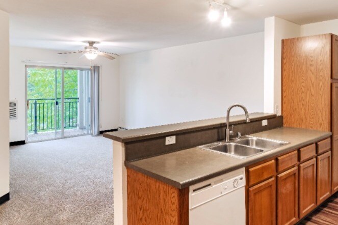 Un dormitorio con balcón - Berkshire Oconomowoc Senior Apartments