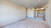 Located at 75 Willow Ct in Boston's 02125 zip code, this single-floor, 3-bedroom, 2-bathroom residence showcases a clean, contemporary design with a cohesive neutral color palette throughout. The layout flows efficiently from a welcoming hallway into well-proportioned living areas and private bedrooms.

Each of the three bedrooms features soft, neutral wall tones, recessed lighting, and large windows that invite abundant natural light and offer views of the surrounding Boston neighborhood. The primary bedroom provides a generous footprint, while the additional bedrooms offer comfortable, versatile spaces. Closeted storage is present in the bedrooms, fitted with sleek white panel doors and matte black hardware.

The two bathrooms are thoughtfully appointed with modern finishes. One bathroom features a soaking tub with full-surround large-format white tile and matte black fixtures, while the second includes a glass-enclosed walk-in shower with matching tile work and matte black accents. Both bathrooms have tile flooring, maintaining a consistent, polished aesthetic.

The open living area connects to a kitchen equipped with light wood cabinetry and tile backsplash. Recessed lighting and neutral flooring unify the space, creating a bright, move-in ready home that balances modern style with functional design.
