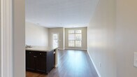 Located at 5730 Silver Falls St in Dublin, Ohio, this single-floor residence offers a practical and comfortable layout across a thoughtfully designed floor plan. The space features warm, neutral-toned walls throughout, creating a cohesive and inviting atmosphere.

The kitchen is outfitted with dark espresso cabinetry, stainless steel appliances including a refrigerator, range, and microwave, along with ample counter space and a double-basin sink. Hardwood-style flooring runs through the kitchen, living, and dining areas, adding warmth and continuity.

The living room is bright and open, benefiting from large windows that allow generous natural light and provide views of the surrounding neighborhood. A glass-panel door offers direct outdoor access. Adjacent to the living area, the layout flows naturally for everyday living.

The bedroom is a comfortable retreat, carpeted for softness underfoot, and features dual windows that bring in additional daylight. A dedicated closet provides convenient storage.

The bathroom includes a dark-cabinetted vanity with a single sink, a combination tub and shower, a large mirror with overhead lighting, and tile flooring, offering a clean and functional space. Overall, the residence presents a tidy, modern aesthetic suited for comfortable single-occupant living.