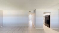 Located at 464 Brentwood Dr in Daytona Beach, FL, this single-story 2-bedroom, 1-bathroom home offers a straightforward and functional layout. The combined living and dining area greets you at the entrance, featuring light ceramic tile flooring, a ceiling fan, and two windows that invite natural light and views of the surrounding neighborhood. A central hallway connects the living space to the rest of the home, with five closets distributed throughout for generous storage. The galley-style kitchen is equipped with white cabinetry, white countertops, a black electric range, and a full-size refrigerator, all set atop easy-care tile flooring. The two bedrooms feature wood-look vinyl plank flooring and textured ceilings, with windows providing natural light and outdoor views. The spacious primary bedroom includes access to the full bathroom, which offers a white vanity, tile flooring, and a tub/shower combination with white tile surround. The second bedroom also benefits from wood-look flooring and a bright window. Neutral wall tones and consistent finishes throughout give the home a clean, cohesive appearance well-suited to comfortable Florida living.