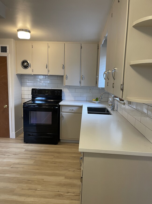 New quartz countertop, LVP flooring, and painted cupboards - 1919 8th Ave