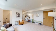 Located at 3483 Larimore Ave in Omaha, NE, this well-designed one-bedroom, one-bathroom residence offers a thoughtful layout across a single floor. The open-concept living area is bright and welcoming, featuring recessed lighting, neutral carpet, and a window that draws in natural light. The space flows seamlessly into the galley-style kitchen, which is outfitted with white shaker cabinetry, white appliances including an electric range, built-in microwave, refrigerator, and dishwasher, along with a subway tile backsplash and ample counter space. A small dining nook with pendant lighting sits just off the kitchen, adding functionality to the compact footprint. The bedroom is a calm, carpeted retreat featuring a window overlooking greenery outside, providing a quiet and comfortable atmosphere. A dedicated closet provides practical storage. The bathroom is clean and efficiently designed, finished in light tones with a vanity, tile flooring, and accessibility-friendly features including a grab bar. Throughout the unit, white walls and recessed lighting create a consistent, modern aesthetic that maximizes the sense of openness in this cozy Omaha residence.