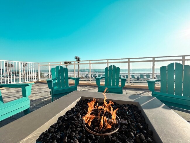 Relax by the fire and soak in the soothing sounds of ocean waves—the perfect escape for tranquility and connection. - Triton Cay - Daytona Apartments