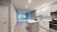 Located at 99 N White Horse Pike in Somerdale, NJ, this thoughtfully designed one-bedroom, one-bathroom residence offers a clean, modern aesthetic with functional living spaces across a single floor. Light gray walls, recessed lighting, and light-toned luxury vinyl plank flooring run throughout, creating a cohesive and contemporary atmosphere.

The open-concept kitchen and living area serves as the heart of the home. The kitchen is well-appointed with white shaker-style cabinetry, crisp white countertops, a full suite of stainless steel appliances including a gas range, built-in microwave, dishwasher, and refrigerator, as well as a central island that offers additional prep and dining space. The living area flows seamlessly from the kitchen and receives natural light through large windows with roller shades, with direct access to a private balcony overlooking the surrounding neighborhood.

The bedroom is generously sized, featuring large windows that bring in ample natural light and outdoor views. Two closets provide practical storage. The full bathroom includes a shower-tub combination, a vanity, and consistent vinyl flooring. A dedicated laundry area adds everyday convenience. The unit also benefits from a smart thermostat and modern hardware details throughout.