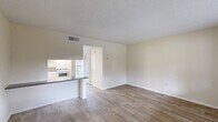 Located at 744 Spring West Rd in Orlando, FL, this one-bedroom, one-bathroom unit offers a well-organized single-floor layout designed to maximize functionality. The combined living and dining area forms the heart of the space, featuring durable wood-look flooring, warm neutral-toned walls, and a textured ceiling throughout. Natural light enters through a large window at the front of the living area, and a front entry door provides direct access. The open layout connects seamlessly to the kitchen, which is separated by a peninsula counter with granite-look countertops. The kitchen is equipped with a gas range, microwave, and white cabinetry, with a window that brings in additional natural light. A sliding glass door in the bedroom leads to a private balcony with views of the surrounding outdoor greenery. The bedroom features plush carpeting, a dedicated closet, and a calm, neutral palette. The bathroom is finished with matching granite-look countertops, a combined shower and tub unit with built-in shelving, and wood-look flooring that ties the space together. Centrally located HVAC vents ensure year-round comfort throughout this efficiently designed residence.