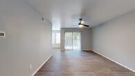 This single-floor residence offers a thoughtfully designed layout encompassing three bedrooms, four bathrooms, and a generous living and dining area. The open living room is finished with rich wood-look flooring, neutral gray walls, and a ceiling fan with light fixture, and features a sliding glass door that invites natural light while providing direct outdoor access. The adjoining dining area continues the same flooring and benefits from a trio of large windows fitted with white blinds, filling the space with abundant daylight. The kitchen is well-equipped, showcasing white cabinetry, granite countertops, a gray subway tile backsplash, a double stainless steel sink, and stainless steel appliances. Each of the three bedrooms is fitted with a ceiling fan, neutral carpet flooring, and windows with blinds, offering a comfortable and functional retreat. The primary bedroom includes its own dedicated closet with built-in shelving and hanging rods. Four closets in total provide excellent storage capacity throughout the residence. The four bathrooms include tiled tub-shower combinations, offering practical, clean-finished spaces. A connecting hallway ties the layout together efficiently, creating a cohesive and livable floor plan.