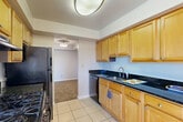 Located at 9562 Muirkirk Rd in Laurel, Maryland, this 2-bedroom, 1-bathroom residence offers a well-organized single-floor layout with a diverse range of rooms designed for comfortable living. The entrance leads into a hallway connecting the main living areas, with three closets throughout providing ample storage.

The kitchen is a functional standout, featuring warm honey-toned wood cabinetry, striking dark granite countertops, tile flooring, and stainless steel appliances including a gas range and dishwasher. Adjacent to the kitchen is a dedicated laundry area and a dining room, with a sliding glass door offering direct access to the private balcony overlooking lush outdoor greenery.

The living room is generously sized, with plush carpeting, a vibrant accent wall, and its own sliding glass door that opens to the balcony, filling the space with natural light and pleasant outdoor views. A dedicated utility room houses the building's mechanical systems.

Both bedrooms are carpeted and feature closets, with the primary bedroom offering a comfortable footprint well-suited for a full bedroom set. The bathroom includes a full tub-shower combination with clean white tile surround. Throughout the residence, neutral tones and practical finishes create a cohesive and livable atmosphere.
