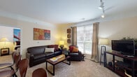 Located at 1084 W Oakland Ave in Johnson City, Tennessee, this single-floor residence offers a thoughtfully designed layout that balances comfort and functionality. The living area is warm and inviting, featuring hardwood-style flooring, crown molding, a ceiling fan, and recessed lighting. An arched passage connects the living room to the rest of the home, adding architectural character. Large windows allow abundant natural light to fill the space, with views of the surrounding neighborhood. The adjacent dining area flows seamlessly from the living room, creating an open and social atmosphere.

The kitchen is well-equipped with rich dark wood cabinetry, granite-style countertops, stainless steel appliances including a gas range, microwave, and refrigerator, a tile backsplash, track lighting, and a center island. A laundry area is conveniently accessible from the kitchen.

Both bedrooms are carpeted and feature large windows that invite natural light. The primary bedroom offers generous proportions, while the second bedroom is equally comfortable. Each bathroom includes granite-topped vanities, tile flooring, and a tub-shower combination, providing practical and well-finished spaces throughout this welcoming home.