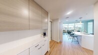 Located in Seattle's vibrant Belltown neighborhood, this modern one-bedroom, one-bathroom residence offers a thoughtfully designed layout with contemporary finishes throughout. Light hardwood flooring flows through the entry and kitchen-living area, complemented by exposed concrete ceilings that add an industrial-chic character to the space.

The open kitchen is well-appointed with flat-front cabinetry in a warm wood tone, white lower cabinets, quartz countertops, a full suite of stainless steel appliances, and an island that doubles as a breakfast bar. Floor-to-ceiling windows in the living area flood the space with natural light and frame sweeping views of the Seattle skyline, creating a bright and airy atmosphere.

The bedroom features plush carpeting, a dedicated track light, and large windows offering additional city views. A separate closet provides organized storage. The bathroom is finished with a white quartz dual-sink vanity, tile flooring, a full-length mirror, and clean, modern fixtures.

A dedicated closet and efficient use of space throughout make this residence a practical and stylish urban retreat in one of Seattle's most walkable and dynamic neighborhoods.