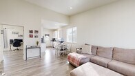 Located at 5703 N Mets Way in Billings, Montana, this 2-bedroom, 1-bathroom single-story home offers a clean, modern design with a warm and welcoming atmosphere. Light-toned walls and wood-style flooring flow consistently throughout, creating a cohesive and airy feel.

The open-concept living area is generously sized, featuring elevated ceilings that enhance the sense of space, large windows that invite abundant natural light, and a view of the surrounding neighborhood. The living room connects seamlessly to a dedicated dining area, making the space ideal for everyday living and entertaining.

The galley-style kitchen is well-appointed with white cabinetry, dark countertops, stainless steel appliances including a refrigerator and range, and an exterior-facing door that brings in additional light. Ample counter and storage space make it both functional and efficient.

The primary bedroom is notably spacious, offering a double-door closet, natural light from a window, and room for a full furniture arrangement. The second bedroom is also well-sized with its own window and closet space. The shared bathroom includes a vanity with dark countertops, white cabinetry, a large mirror, and a tub-shower combination with a curtain enclosure, all finished with the same light flooring found throughout the home.