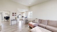 Located at 5703 N Mets Way in Billings, Montana, this 2-bedroom, 1-bathroom single-story home offers a clean, modern design with a warm and welcoming atmosphere. Light-toned walls and wood-style flooring flow consistently throughout, creating a cohesive and airy feel.

The open-concept living area is generously sized, featuring elevated ceilings that enhance the sense of space, large windows that invite abundant natural light, and a view of the surrounding neighborhood. The living room connects seamlessly to a dedicated dining area, making the space ideal for everyday living and entertaining.

The galley-style kitchen is well-appointed with white cabinetry, dark countertops, stainless steel appliances including a refrigerator and range, and an exterior-facing door that brings in additional light. Ample counter and storage space make it both functional and efficient.

The primary bedroom is notably spacious, offering a double-door closet, natural light from a window, and room for a full furniture arrangement. The second bedroom is also well-sized with its own window and closet space. The shared bathroom includes a vanity with dark countertops, white cabinetry, a large mirror, and a tub-shower combination with a curtain enclosure, all finished with the same light flooring found throughout the home.