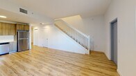 This contemporary townhouse in Homestead, FL offers 1,160 square feet of living space across two floors. The property features three bedrooms, including a generous 180 square foot primary bedroom, and two full bathrooms. The interior showcases a modern design with an emphasis on clean lines and bright, open spaces.

The ground floor spans 590 square feet and includes an open-concept kitchen and living area. The kitchen boasts sleek, light wood cabinetry, stainless steel appliances, and a tiled backsplash. Light-toned wood-look flooring extends throughout the main living areas, creating a cohesive and airy atmosphere.

Upstairs, the 570 square foot second floor houses the bedrooms and additional bathroom. Large windows in the bedrooms allow for ample natural light, while built-in closets offer practical storage solutions. The bathrooms feature contemporary fixtures, including floating vanities and glass-enclosed showers.

The exterior of the townhouse is characterized by a clean white facade with striking blue accents. A small, private outdoor area with artificial turf provides a pleasant space for relaxation. The property's modern design extends to its surroundings, with well-maintained walkways and landscaping.

Located at 24705 SW 129th Ave in Homestead, this townhouse combines style and functionality in a compact yet comfortable living space.