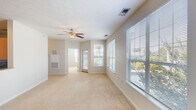 Located at 3307 Woodhill Ln in Fayetteville, NC, this single-story home offers a practical and comfortable layout with a neutral, move-in-ready aesthetic throughout. The main living area is generously proportioned, featuring wall-to-wall carpeting, soft beige walls, and a ceiling fan with a built-in light fixture. Multiple windows fitted with horizontal blinds line the walls, allowing abundant natural light to fill the space while offering views of the surrounding greenery. A door provides direct access to an outdoor area, enhancing the connection between interior and exterior. The living space flows openly toward the entry, which features tile flooring for easy maintenance near the front door.

The kitchen is equipped with warm wood-toned cabinetry, granite-style countertops, and black appliances including a range and refrigerator. A peninsula counter serves as a transitional element between the kitchen and adjacent areas, offering additional workspace. Tile flooring in the kitchen provides a durable, easy-to-clean surface.

The bathroom is well-appointed, featuring a dual-sink vanity with granite countertops, rich wood cabinetry, and framed mirrors above each sink. A soaking tub and separate shower area complete the space, while tile flooring and a window add brightness and functionality. Overall, the home presents a clean, practical living environment.