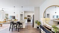 Located at 1001 Sundial Cir in Sneads Ferry, NC, this thoughtfully designed 2-bedroom, 2-bathroom single-floor residence offers a comfortable and modern living experience. The open-concept kitchen is a standout feature, showcasing white shaker cabinetry, granite countertops, a tile backsplash, stainless steel appliances including a French door refrigerator and range, and a kitchen island with pendant lighting and bar seating — ideal for both everyday cooking and entertaining. Wood-look flooring flows through the main living areas, adding warmth and cohesion throughout. The living room is bright and inviting, featuring a ceiling fan and sliding glass door access to a private balcony with outdoor views. The primary bedroom offers plush carpeting, large windows with natural light, and a bold accent wall, accompanied by an en suite bathroom with a granite vanity and glass-enclosed walk-in shower. The second bedroom features a soothing color palette, ceiling fan, and ample space. A second full bathroom includes a soaking tub with shower. Additional highlights include a spacious walk-in closet with wire shelving and a dedicated in-unit laundry area with a full-size washer and dryer.