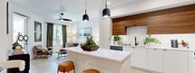 This contemporary 650 square foot apartment in San Diego offers a thoughtfully designed living space. The single bedroom, measuring 140 square feet, showcases a modern aesthetic with a comfortable bed, stylish wooden dresser, and eye-catching circular mirror. The living area is bathed in natural light from large windows and features a plush sofa, accent chair, and modern coffee table, creating an inviting atmosphere for relaxation.

The kitchen boasts a sleek design with warm wood upper cabinets contrasting crisp white lower cabinets, stainless steel appliances, and a functional island. The bathroom continues the modern theme with a floating vanity, glass-enclosed shower, and clever storage solutions.

Throughout the apartment, light wood flooring adds warmth and continuity. The space is further enhanced by carefully curated artwork and greenery, adding personality and life to each room. A compact yet well-organized closet provides ample storage space.

The apartment's efficient layout maximizes the use of space, making it feel larger than its actual square footage. With its combination of style and functionality, this apartment offers a perfect urban retreat in the heart of San Diego.