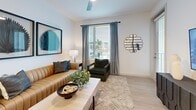 Located in Saint Petersburg, FL, this well-appointed 2-bedroom, 2-bathroom single-floor residence offers a thoughtfully designed open-concept layout. The combined kitchen, dining, and living area serves as the heart of the home, featuring light wood-tone flooring throughout. The contemporary kitchen is equipped with stainless steel appliances — including a range, microwave, refrigerator, and dishwasher — complemented by warm wood cabinetry, white quartz countertops, and a central island with pendant lighting and bar seating. The living area is bright and welcoming, with large windows allowing generous natural light and views of the surrounding area. The primary bedroom is a spacious retreat with direct access to an en-suite bathroom, which features a wood-toned vanity with quartz countertops and a backlit mirror. The second bathroom includes marble-style tile flooring and walls with a full soaking tub and shower. Both bedrooms offer ceiling fans and large windows. The residence also boasts six closets — including well-organized walk-in storage with built-in shelving — a hallway, and a private balcony. The clean, neutral palette and modern finishes create a cohesive and contemporary ambiance throughout.