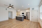 Located at 277 Clifton St SE in Atlanta, GA, this modern single-story unit offers a thoughtfully designed open-concept layout. Light-toned hardwood-style flooring flows seamlessly throughout the entire space, creating a cohesive and airy feel.

The combined kitchen and living area serves as the heart of the home. The kitchen is a standout feature, equipped with stainless steel appliances including a French door refrigerator, electric range, and built-in microwave. Crisp white upper cabinetry is paired with dark wood-toned lower cabinets, and a large center island with a white quartz countertop and undermount sink provides both prep space and seating. Recessed lighting illuminates the kitchen, while a ceiling fan enhances comfort in the living area. A glass door in the living room invites natural light and provides exterior access.

The bedroom is a bright, well-proportioned retreat featuring a ceiling fan, a natural light-admitting window, and a sliding double-door closet. The bathroom is cleanly appointed with a tub/shower combo featuring subway tile surround, matte black fixtures, a dark wood vanity with white countertop, and a large frameless mirror. The unit's crisp white walls and modern finishes throughout give it a fresh, contemporary character.